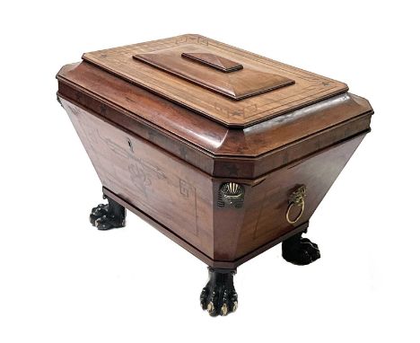 A Regency mahogany cellarette, circa 1820, in the manner of Thomas Hope, of sarcophagus form with hinged cover, strung and pa