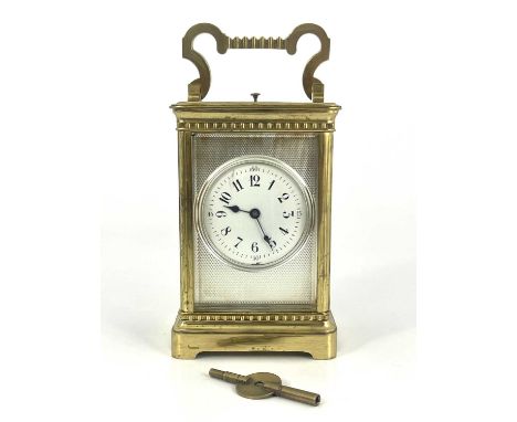 A French repeating carriage clock, early 20th Century, gilt metal corniche case with swing handle, visible escapement, white 