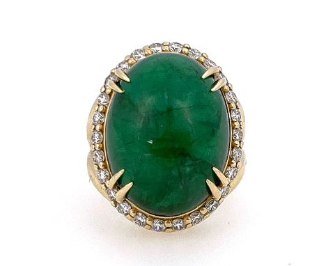 A large cabochon emerald and diamond cluster ring, 14 carat gold, the central green stones within a band of brilliant cut sto