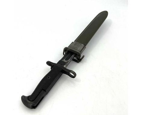 A Second World War US M1 Garand bayonet by Utica Cutlery, two piece bakelite grip, housed in green plastic and steel mounted 