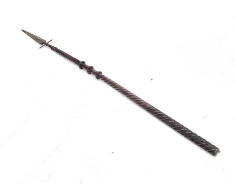 A 19th century spontoon, mounted on a Continental carved shaft, the steel leaf blade with cross bar and two ring neck, wrythe