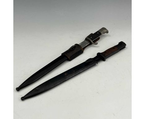 Two German bayonets, including a Third Reich bayonet, two piece black chequered grip, housed in black steel scabbard with lea