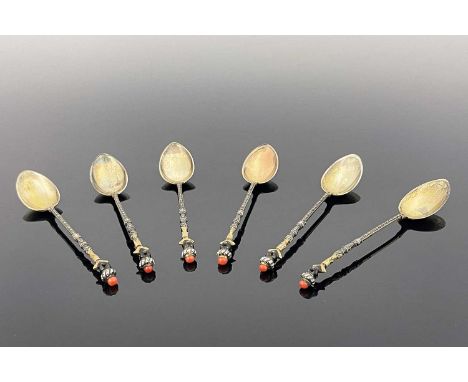 A set of six Continental silver gilt and enamelled figural Blackamoor teaspoons, Austrian import marks, circa 1880, cast in t
