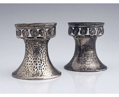 A pair of Arts and Crafts silver pedestal salt cellars, William Hutton and Sons, London 1903, planished splayed feet with ret