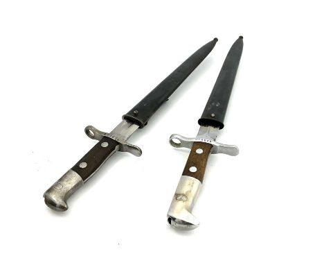 Two Swiss bayonets, a Swiss M1889 bayonet, two piece wooden grip, housed in blackened steel scabbard with leather tab,ricasso