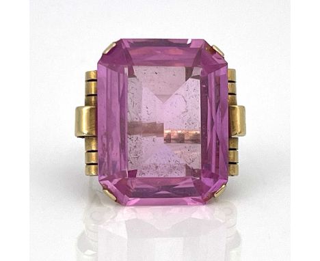 A yellow gold ring, set emerald-cut pink stone, (possibly synthetic)