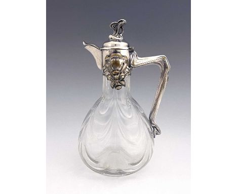 A Jugendstil silver plate and glass claret jug, circa 1900, the optic swag moulded body of bulbous form with relief cast iris