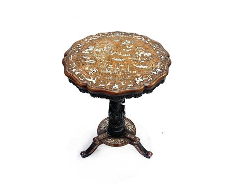 A Chinese hardwood tripod occasional table, mid to late 19th Century, serpentine-edged circular top, fretwork frieze, dragon 