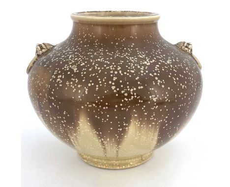 An Oriental style porcelain vase, squat baluster form, relief moulded dog mask and ring handles, speckled glaze