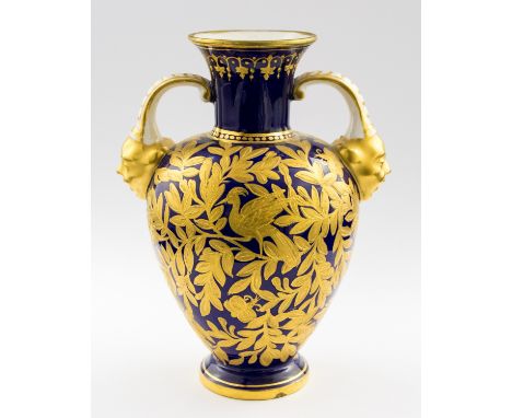 A Royal Crown Derby vase, twin handled shouldered form, tooled gilt foliate carpet ground with birds, mask handles, 15cm high