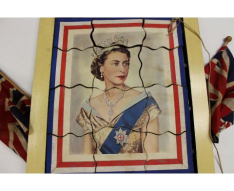 Vintage 1950s magic trick / jigsaw depicting portrait of Queen Elizabeth II with Union Jack flags suspended from edges. Toget