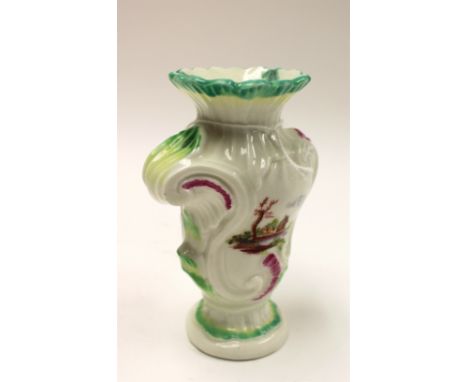 A Derby porcelain Rococo scroll moulded vase, circa 1760, asymmetrical, each side with a painted landscape. patch marks, 14cm