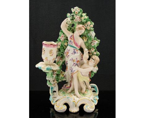 A Derby porcelain figural candlestick, modelled and a woman and putto with boccage, incised marks, 22cm high