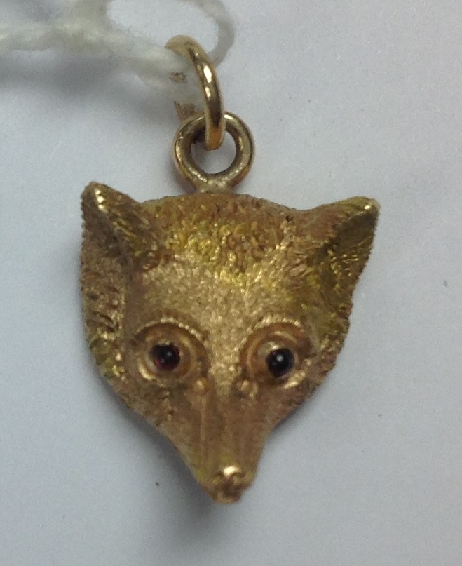 Gold Fox head pendant with detailing to the fur, eyes set with