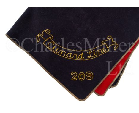 A CUNARD LINE FIRST CLASS WOOLLEN DECK BLANKET, CIRCA 1936 of navy blue and scarlet, embroidered with banner for Cunard Line 