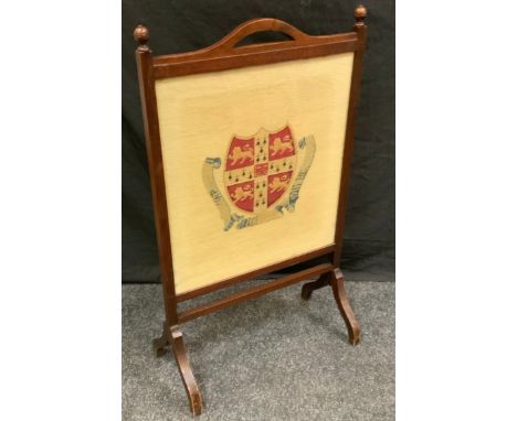 An early 20th century oak rectangular fire screen, turned finials, the tapestry banner with Cambridge University crest, 95cm 