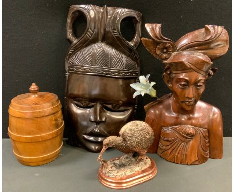 An African hardwood figure;  a similar mask;  a turned wooden tea caddy;  a copper kiwi 