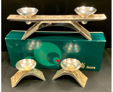 A Kurt Radke for WMF brushed steel three piece candle garniture, comprising two light candelabra, pair of single light candle