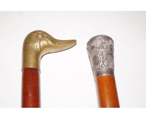 Walking stick with ornate Eastern white metal knop, possibly silbver, together with a further walking stick with stylised han