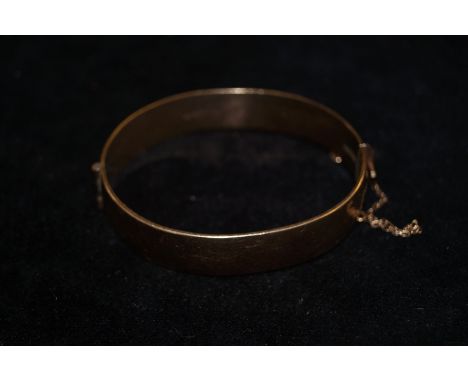 1/6 9ct metal core bangle set with red stones. Weight 34.5 grams