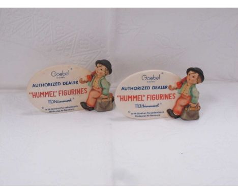 'Hummel Figurines' Oval Display Plaques, 'Authorised Dealer', free standing with boy to side, 9cm high, 14.5cm wide (2).