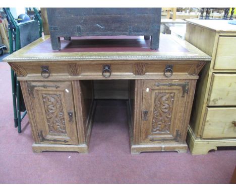 XX Century Oak Continental Pedestal Desk, with a cross banded top, three top drawers with ring handles, pedestals with carved