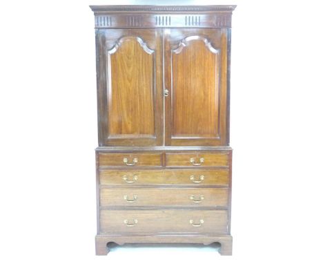An Edwardian mahogany press cupboard, in George III style, two cupboard doors open to reveal three press slides, the base sec