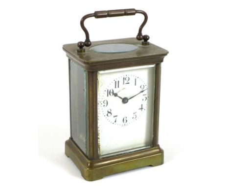 A French Art Deco brass carriage clock, five glass case, the white enamel dial with black Arabic numerals, signed 'France', w