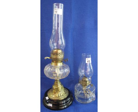 Early 20th Century brass double burner oil lamp with thumb cut glass reservoir on repousse brass column with ceramic base and