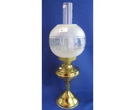 Brass double burner oil lamp with brass reservoir and base, frosted glass shade and clear chimney. 