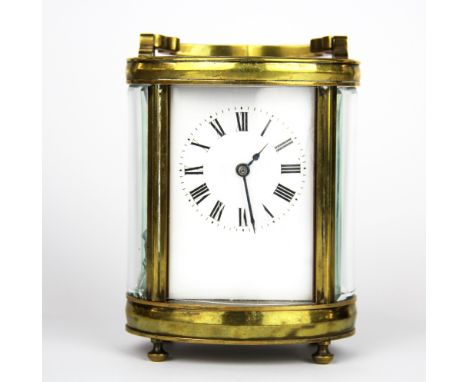 An oval brass carriage clock, H. 12cm.