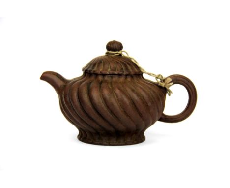 A Chinese Yixing terracotta teapot, H. 11cm, spout to handle 18cm.