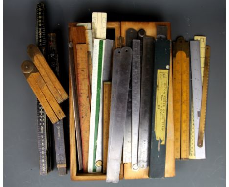 A quantity of vintage folding and other wooden and steel rulers.