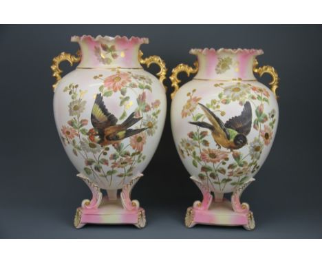 A pair of 19th century ceramic vases, H. 38cm. One handle restored.