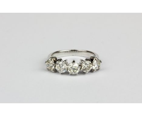 An 18ct white gold (stamped 750) ring set with five brilliant cut diamonds, approx. 2ct overall, (N).