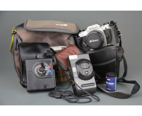 A Nikon FG camera with 52mm lens with a Canon Snappy and a Nikon Speedlight SB-15.
