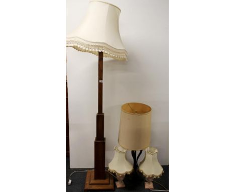 An Art Deco standard lamp with shade with a table lamp and two Wedgwood style lamps.
