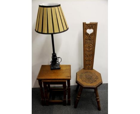 A Welsh oak carved spinning chair, together with two oak side tables and a table lamp.