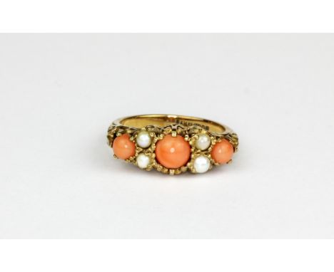 A 9ct gold ring set with cabochon cut coral and pearls, (K.5).