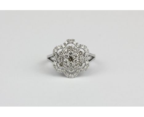 A 18ct white gold (stamped k18) flower shaped cluster ring set with brilliant cut diamonds, approx. 1ct overall, (M.5).