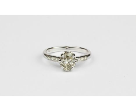 An 18ct white gold (worn stamp 750) ring set with an oval cut brilliant cut diamond and diamond cut shoulders, approx. 1.82ct