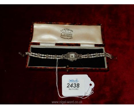 A pretty ladies wrist watch decorated with pearls, stainless steel detailing and Mother of Pearl watch face.