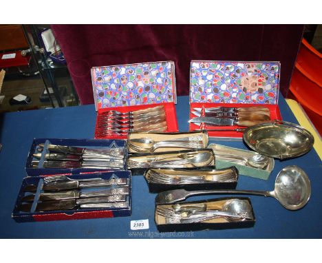 A quantity of plated cutlery including community, steak knives and forks, a large ladle, sweet basket, etc.  