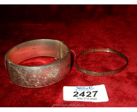 A silver bangle with hallmarks for Birmingham 1965, maker Smith &amp; Pepper Ltd , with engraved front, some dings, plus anot
