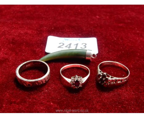 Three silver rings and a Jade pendant.
