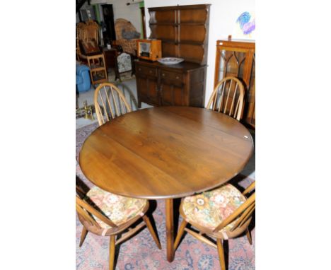 Ercol dark wood dining suite comprising of drop leaf table, four stick back dining chairs and dresser with two tier raised ba