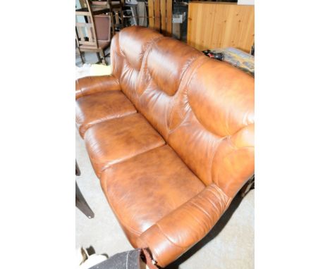 Brown leather suite comprising of three seater sofa and matching armchair with wooden trim