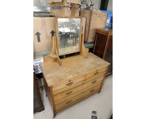 Late Victorian oak dressing chest with mirror back above two short and two long drawers