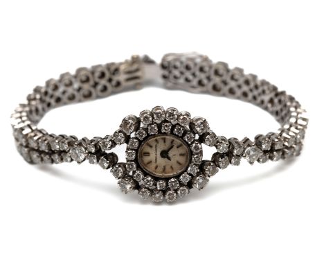 Jaeger leCoultre, 18 kt. witgouden mechanisch damespolshorloge. De band en lunette volledig bezet met briljant geslepen diama