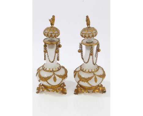 Pair of 19th century Bohemian opaque glass and gilt metal mounted scent flasks and stoppers, each stopper with figural finial